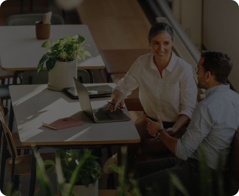 Two business people talking at a desk